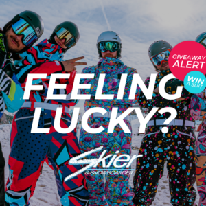 WIN an OOSC ski suit worth £329 Five snowboarders in colourful retro-patterned onesies and goggles pose together on a snowy slope beneath a "Feeling Lucky? Win a suit" giveaway graphic.